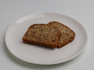 slice of banana bread on white background