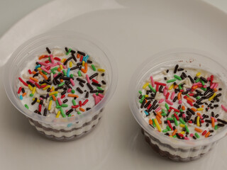 Sweet dessert in a cup with sprinkle on top
