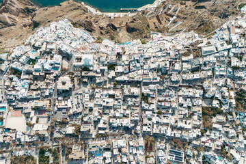 Naklejka premium Aerial drone photo of beautiful Fira town on Santorini with white houses and dense layout