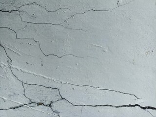 Cracked White Wall Texture with Fine Surface Detail. Close-up of cracked white wall surface with...