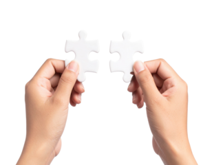 Two hands each holding a white puzzle piece, positioned to fit them together.