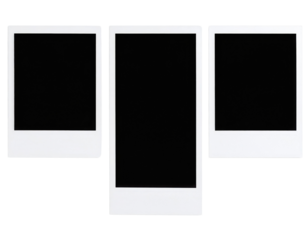 Three blank instant photo frames with white borders arranged side by side on a black surface.