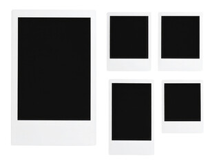 Five blank instant photo frames of varying sizes with white borders arranged against a dark surface.