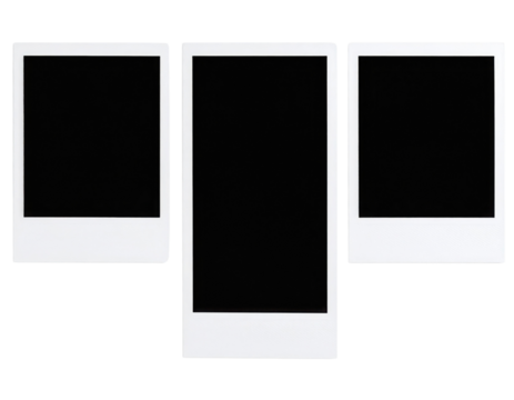 Three blank instant photo frames with white borders arranged side by side on a black surface.