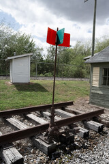 red and green railroad signal post