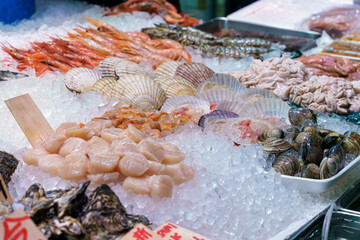 Fresh various seafood display on ice in fish market