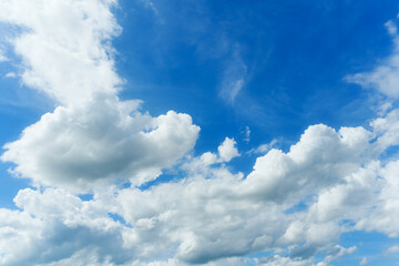 White fluffy clouds in blue sky on sunny day