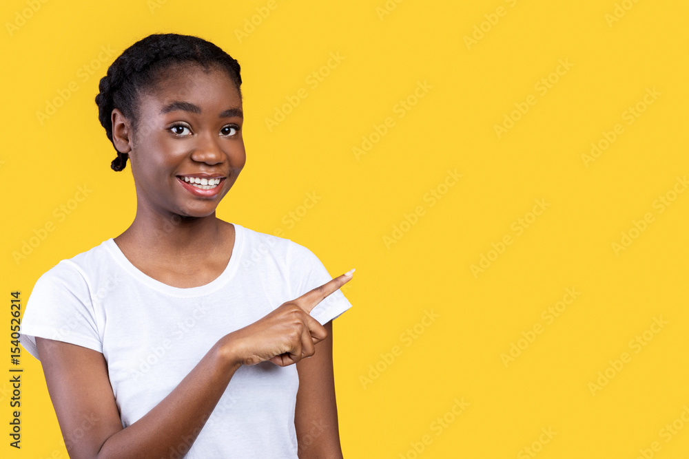 Aufkleber look there. smiling african woman pointing finger aside at free space advertising your text standing