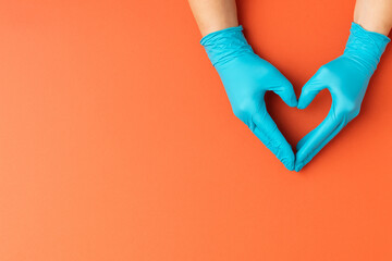 Healthcare theme with gloved hands shaped as a heart showing support, safety, and love.