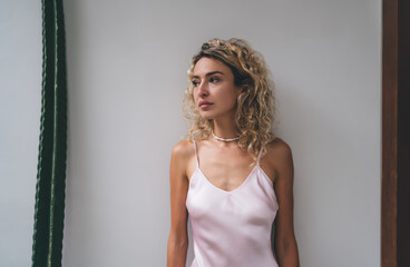 Playful skip in slip dress, woman smiles—a moment of joyful tech-life harmony where spontaneous...