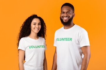 Volunteering Work. Female And Male Multiracial Volunteers Posing Smiling To Camera Wearing White...