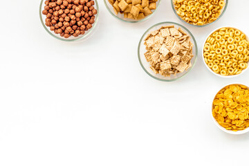 cereals, oatflakes and cornflakes for healthy breakfast on white background top view mock up