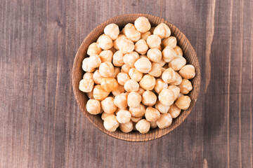 Organic hazelnuts in a wooden bowl. Vegan food concept. 