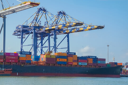 Cargo containers loading on cargo ship at container terminal at port kochi of CMA CGM, Maersk, COSCO Shipping, Hapag-Lloyd, Evergreen Line, MSC (Mediterranean Shipping Company), NYK Line, ONE Shipping