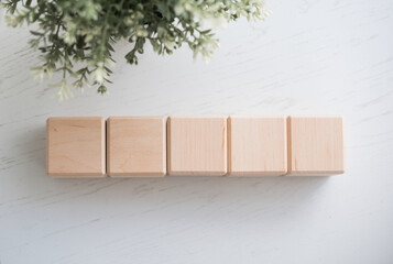 Wooden blocks mockup with decorative greenery