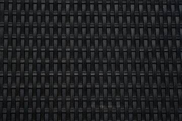 Black woven rattan texture close-up with geometric pattern
