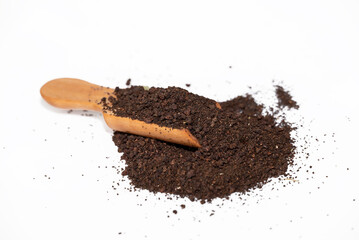 black tea powder in the wooden spoon isolated on white background.