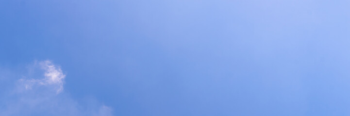 Clear blue sky with a few clouds. The sky is very bright and the clouds are scattered throughout