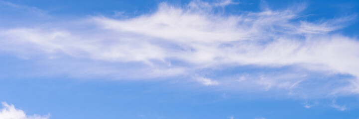 Fototapeta premium Clear blue sky with a few clouds. The sky is very bright and the clouds are scattered throughout