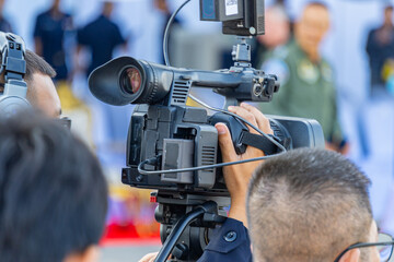 A photographer is using a video camera to report the news.