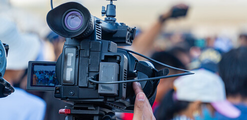 A photographer is using a video camera to report the news.