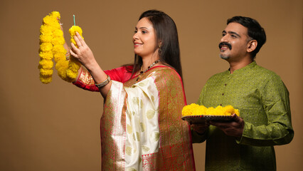 Portraits of young Couple wearing traditional outfits on festival