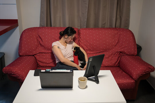 Woman multitasks working from home with her puppy