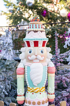 Festive nutcracker decoration amidst snowy trees