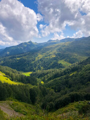 Fototapeta premium Clouds drifting over mountain peaks in Abkhazia, creating a dramatic and serene landscape