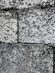 Close-up of textured concrete cinder block wall in vertical format
