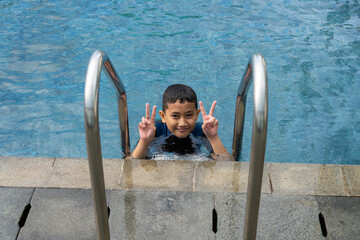 Boy Swimming Pool Posing Victory Gesture Near Ladder Relaxing Vacation Fun