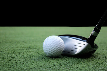 Golf Club and Ball on Green Turf Ready for a Swing