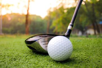 Close-up of Golf Club and Ball on Lush Green Grass at Sunset