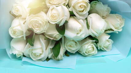 Bouquet of white roses on a blue background. Greeting card.