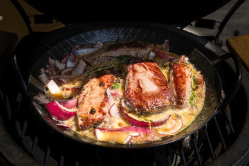 bbq grilling game meat from a chamois in a pan on a charcoal grill
