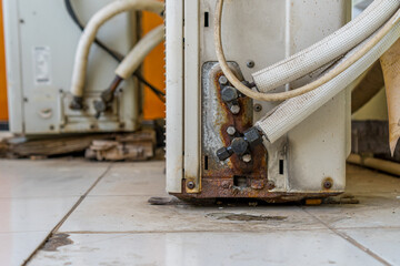 Examining Leaking and Rusty Air Conditioner Units Needing Repair or Replacement