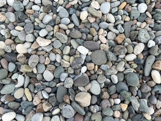 Top view of colorful round beach stones and smooth pebbles as natural texture background