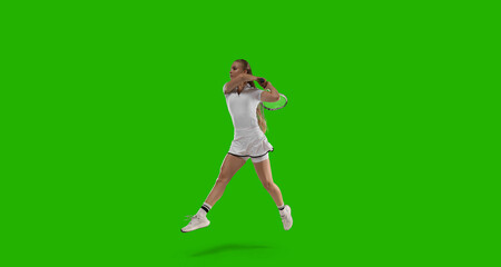 Woman tennis player playing tennis on green screen background.