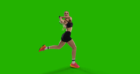 Woman tennis player playing tennis on green screen background.