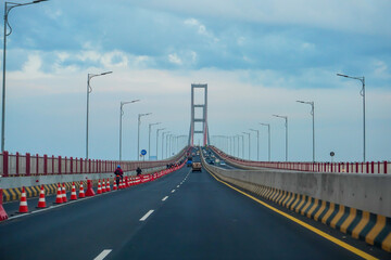 Driving on Long Bridge Towards Towers with Traffic and Sky