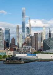 Tall office and apartment buidlings along the waterfront of Hells Kitchen in Manhattan seen from a ship on Hudson