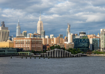 Tall office and apartment buidlings along the waterfront in Manhattan by Pier 57 and Little Island seen from Hudson