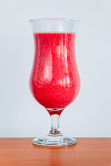 Glass of tasty strawberry smoothie with yoghurt.