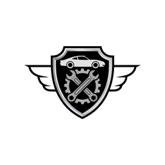 Fototapeta premium Vector emblem of a chrome automotive shield with gear symbol in the center, small car silhouette above, and symmetrical wings. Premium repair service concept, no text, no gradients, white background.
