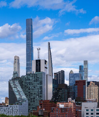 Tall office and apartment buidlings along the waterfront of Hells Kitchen in Manhattan seen from a ship on Hudson