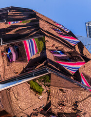 The Vessel, a unique honeycomb-shaped public landmark at Hudson Yards, reflects back the scene from the sidewalk
