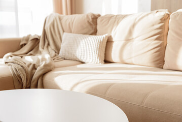 Empty white coffee table in a cozy living room with a beige couch.