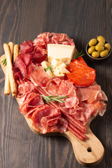 Charcuterie board. Antipasti appetizers of meat platter with salami, prosciutto crudo or jamon and...