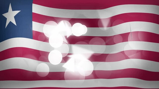 Liberian flag waving as bokeh circles appear, glowing triangles drift then fade to celebrate pride