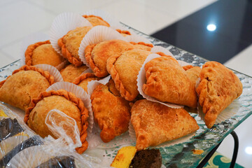 Delicious Curry Puff Pastries on a Glass Tray for Serving Guests